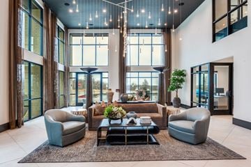 Lewisville apartment for rent - A modern living room with a large window and a rug on the floor.