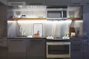 Portland apartment for rent - a small kitchen with gray cabinets and stainless steel appliances