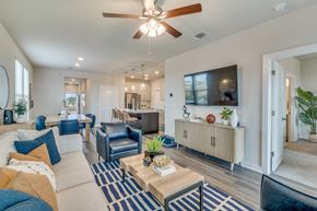 Leander apartment for rent - a living room with blue and white furniture and a ceiling fan