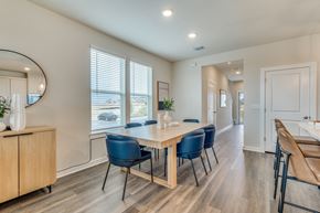 Leander apartment for rent - a dining room with a wooden table and blue chairs