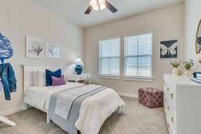 Leander apartment for rent - a bedroom with a bed and a dresser and a ceiling fan