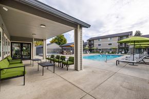 Vancouver apartment for rent - A patio with a pool and a green umbrella.