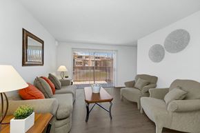 Tucson apartment for rent - A living room with a couch, chairs, and a table.