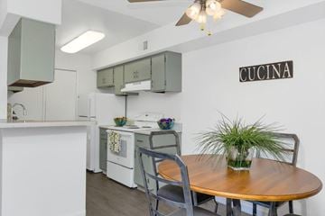 Tucson apartment for rent - A kitchen with a table and chairs and a sign that says Cucina.