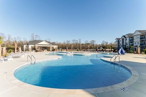 Florence apartment for rent - A large outdoor swimming pool with a slide and a building in the background.