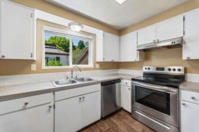 Eugene apartment for rent - A kitchen with white cabinets and stainless steel appliances.