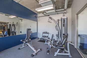 A gym with a blue wall and a mirror