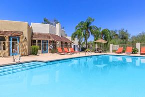 Tucson apartment for rent - A pool with a building behind it.