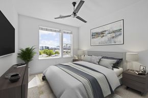 Denver apartment for rent - A bedroom with a large bed and a ceiling fan.