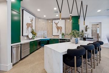 Universal City apartment for rent - A kitchen with green cabinets and a white island.
