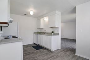 Ogden apartment for rent - A kitchen with white cabinets and a granite countertop.