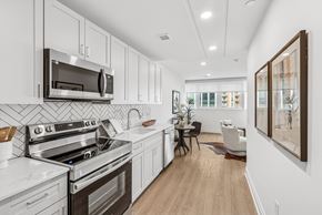 Silver Spring apartment for rent - A modern kitchen with white cabinets and stainless steel appliances.