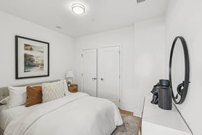 Silver Spring apartment for rent - A bedroom with a large bed and a framed picture on the wall.