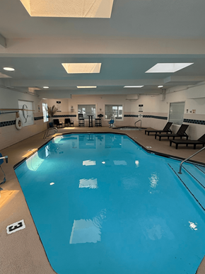 Kennewick apartment for rent - A large indoor swimming pool with lane markers and a starting block.