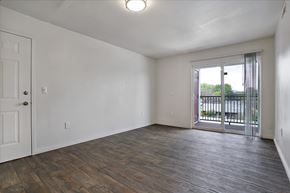 Holladay apartment for rent - A room with a white door and a window with a view of a fence and trees.