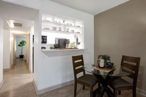Tucson apartment for rent - A dining room with a glass table and chairs.
