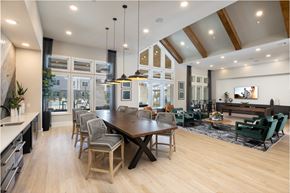 Spring apartment for rent - a large dining room with a wooden table and chairs