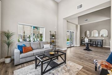 Sacramento apartment for rent - A living room with a grey couch and a black coffee table.