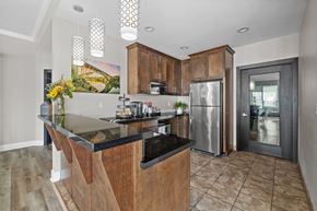 Fair Oaks apartment for rent - A kitchen with a black counter top and wooden cabinets.