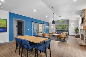 Gresham apartment for rent - A modern dining room with a wooden table and blue chairs.