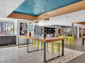 Las Vegas apartment for rent - A modern office space with a long table and chairs.