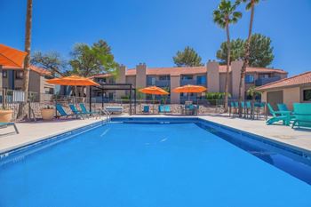 Resort style pool with orange umbrellas