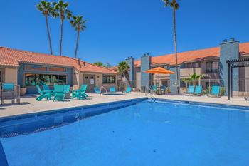Resort style pool with turquoise lounge chairs