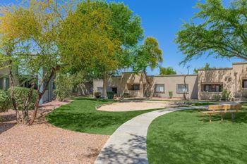 Apartment community courtyard with walking path and landscaping