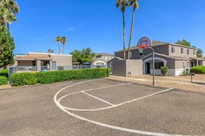 Sierra Vista apartment for rent - A basketball court is located in front of a building with a basketball hoop.