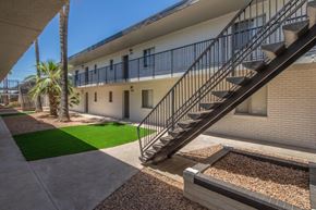 Tucson apartment for rent - A building with a staircase and a palm tree.at Icon Apartments, Tucson, AZ