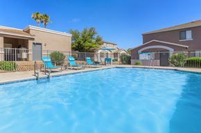 Sierra Vista apartment for rent - A swimming pool surrounded by chairs and a fence.