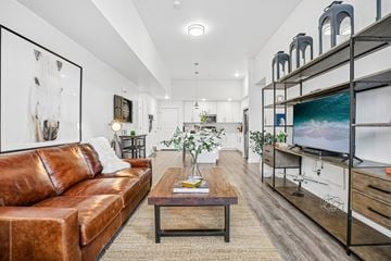 Bluffdale apartment for rent - A living room with a brown leather couch and a wooden coffee table.