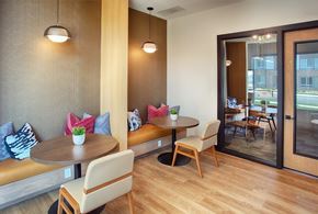 Aurora apartment for rent - A modern dining area with a round table and chairs.