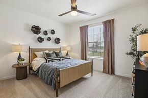 Manor apartment for rent - A bedroom with a large bed and a ceiling fan.