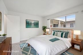 Huntington Beach apartment for rent - A bedroom with a large bed and a painting on the wall.