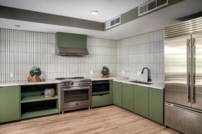 Santa Ana apartment for rent - A modern kitchen with green cabinets and stainless steel appliances.
