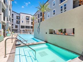 Las Vegas apartment for rent - A swimming pool in a residential area with a building in the background.