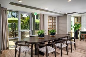 Santa Ana apartment for rent - A dining room with a table and chairs and a window with a view of the outside.