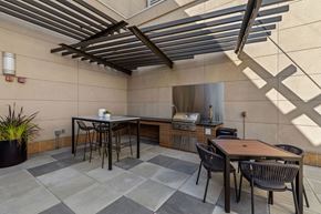 Seattle apartment for rent - a patio with tables and chairs and a kitchen