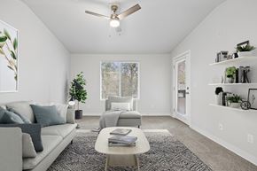 Everett apartment for rent - A living room with a grey couch, a coffee table, and a ceiling fan.