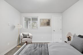 Everett apartment for rent - A bedroom with a bed, chair, and painting on the wall.