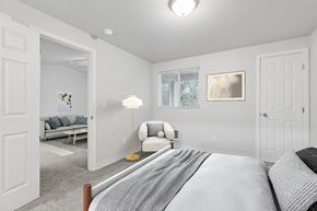 Everett apartment for rent - A bedroom with a bed, a chair, and a lamp.