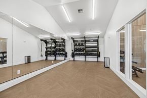 Lynnwood apartment for rent - A gym with wooden floors and mirrors on the wall.