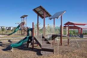 Aurora apartment for rent - A playground with a green slide and a red and white striped slide.