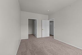 Broomfield apartment for rent - A room with carpeted floor and two open doors.