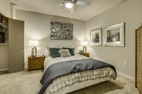 Seattle apartment for rent - A bedroom with a large bed and a ceiling fan.