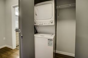Seattle apartment for rent - A white dishwasher is in a narrow space between a wall and a door.