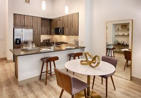 Denver apartment for rent - A modern kitchen with a dining table and chairs.