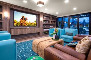 Tacoma apartment for rent - A living room with a large screen television and comfortable seating.