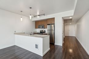 Seattle apartment for rent - A kitchen with a white counter and a stainless steel refrigerator.
